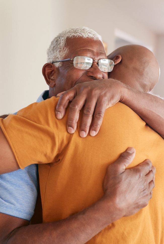 father hugging son struggling with addiction